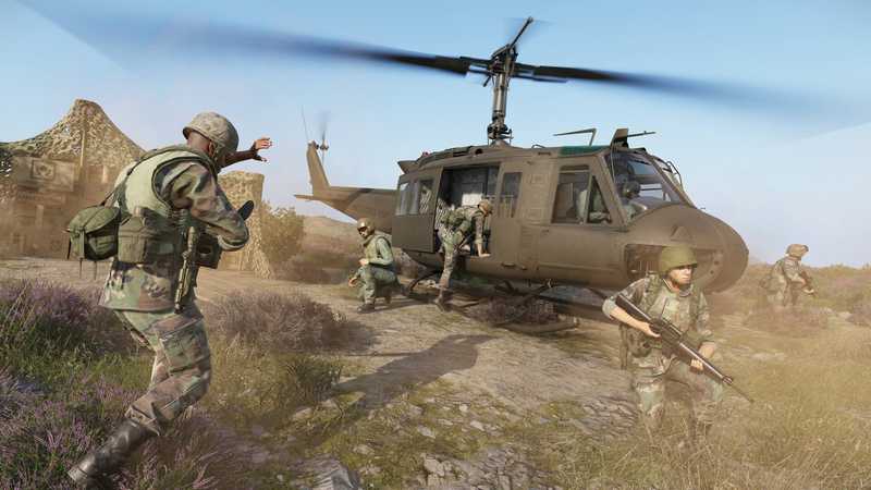 Soldiers running from a helicopter that just landed in a field in Arma Reforger