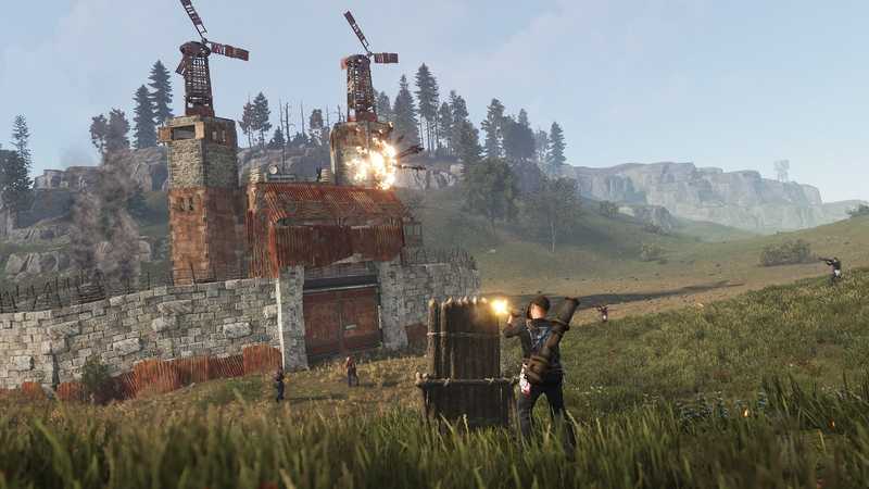 A walled Rust base compound with wind turbines while a player fires from behind cover